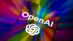 The OpenAI logo is displayed on a mobile phone screen in this photo illustration, as artificial intelligence tools continue to expand across consumer and business applications in Brussels, Belgium, on February 28, 2026. (Photo by Jonathan Raa/NurPhoto)