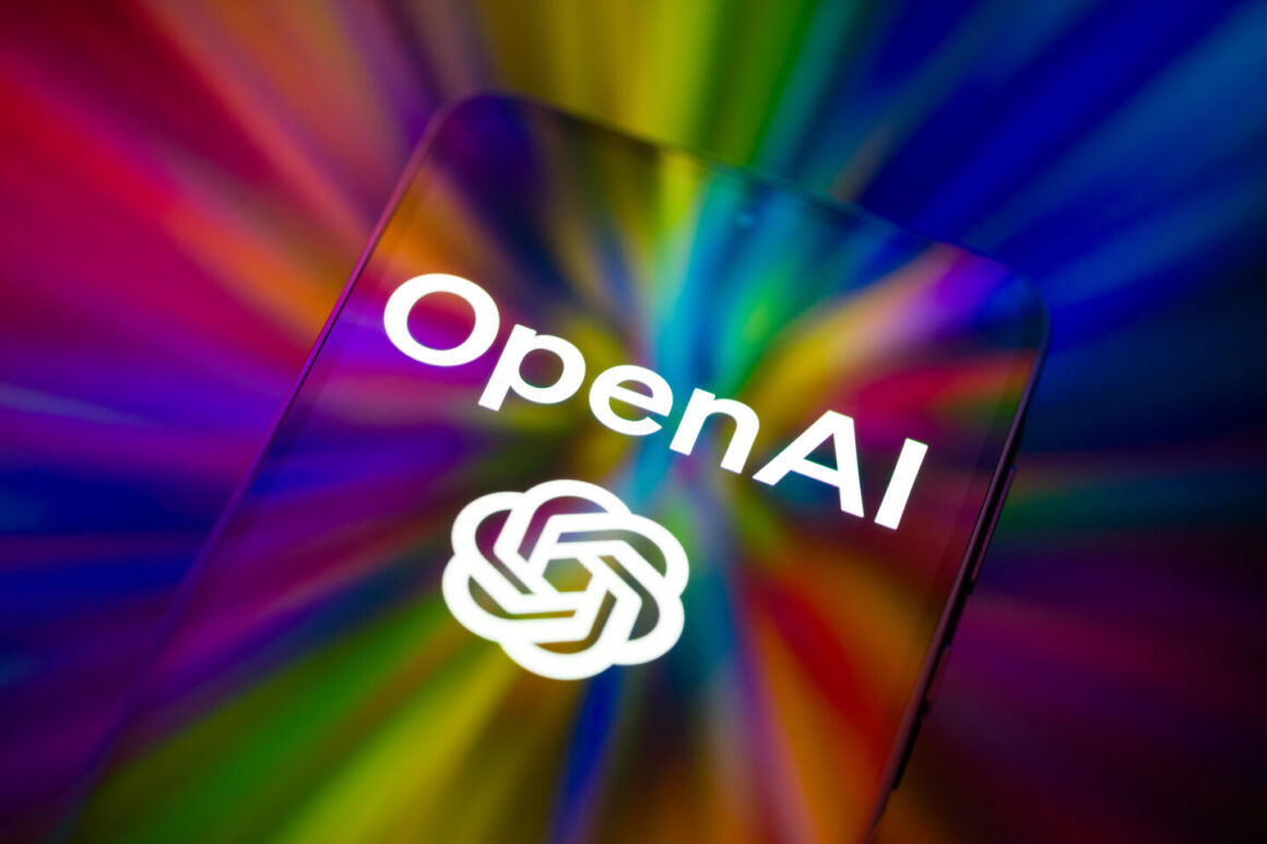 The OpenAI logo is displayed on a mobile phone screen in this photo illustration, as artificial intelligence tools continue to expand across consumer and business applications in Brussels, Belgium, on February 28, 2026. (Photo by Jonathan Raa/NurPhoto)